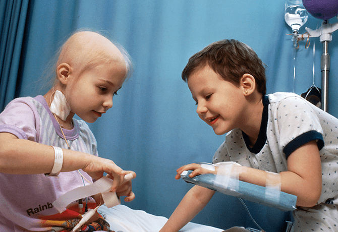 A boy and girl play with bandages on their hands.