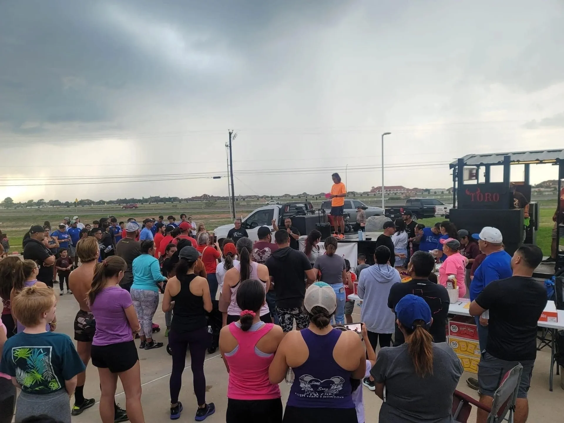 A crowd of people standing in front of a truck.